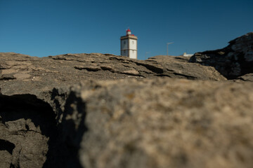 Wall Mural - Rock view in selective focus with the Lighthouse of Cape Carvoeiro in the background. Peniche, Portugal, Europe.