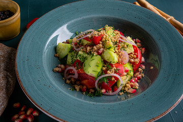 Canvas Print - fresh salad of tomato cucumbers onions on a plate in a restaurant