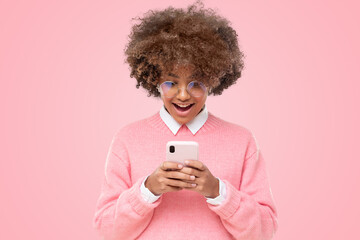 Wall Mural - Shocked happy african girl with wow face, holding phone with both hands, surprised by message