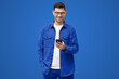 © Damir Khabirov - Smiling man wearing casual blue shirt looking at phone