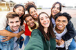 © Xavier Lorenzo - Funny young group of united multiethnic friends taking selfie portrait photo outdoors - Millennial diverse teenager people having fun laughing and celebrating together in street - Community concept