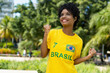 Cheering brazilian female football fan with yellow jersey