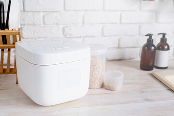 Wall Mural - Electric rice cooker on wooden counter-top in the kitchen