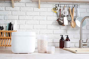 Wall Mural - Electric rice cooker on wooden counter-top in the kitchen