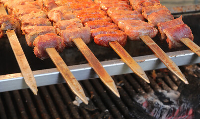 Sausages cooked on a spit over the glowing embers in the restaurant