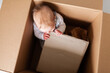© Austockphoto - Baby playing with cardboard in box - moving house with growing family concept