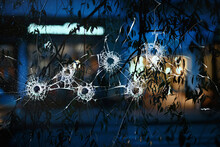 Abstract Simulation Blurred View Of The City Bullet Holes On The Window Glass, Shooting War Background Attack