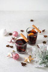 Wall Mural - Close up of two glasses of hot mulled wine and Christmas decorations