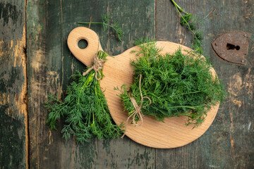 Wall Mural - Fresh dill close up on wooden box on dark background, preparation for freezing serving size organic healthy ething natural product portion. place for text