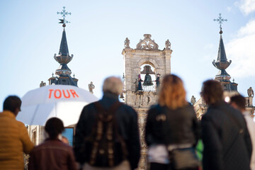 travel tour in vacation for tourist with guide with umbrella that showing them the monumental city ,