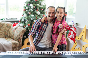 Wall Mural - father and daughter playing the piano at christmas