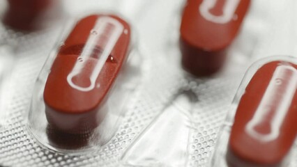 Poster - red capsules in a blister are rotated in a circle