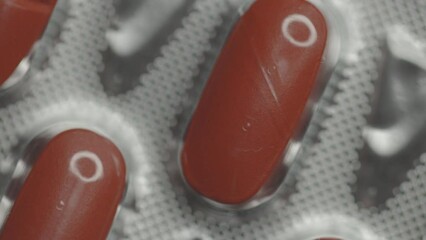 Poster - red capsules in a blister are rotated in a circle