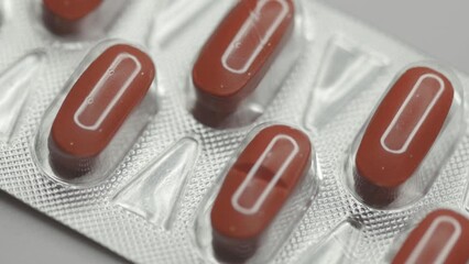 Poster - red capsules in a blister are rotated in a circle