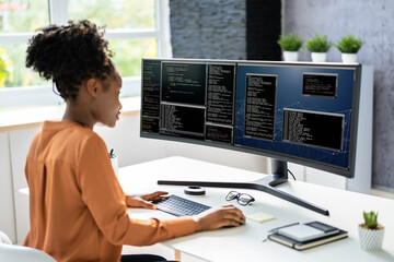 Computer Programmer Writing Program Code On Computer