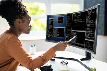 Computer Programmer Writing Program Code On Computer
