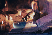 Magic Potions, Ancient Spell Book And Lit Candles