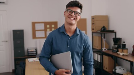 Poster - Young hispanic man business worker smiling confident holding laptop at office