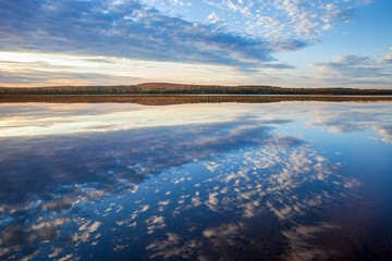 Wall Mural - beautiful calm lake with cloudscape reflecting and hills with trees in autumn color in northern minn