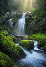 Tropical Waterfall With Rocks And Green Moss