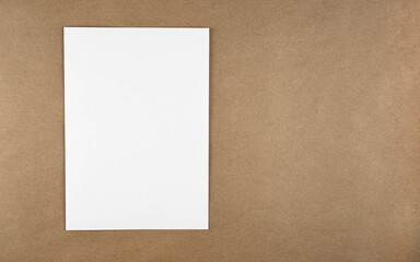 Poster - A notebook in a minimal style top view isolated on brown background of recycled craft vintage paper