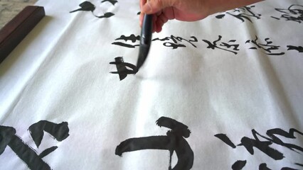 Wall Mural - an old calligrapher affixes seals to calligraphy works, seal carving and seals.