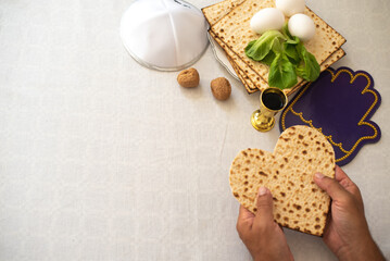 Wall Mural - man's hands holds Matzah shape of heart. Traditional of Jewish Holiday on Passover. Home symbol of lovely family. top view, layout. love and care. Gift for lovers. Feeling in love and blissful life