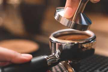 barista making a coffee from coffee powder. closeup of small business of coffee shop.