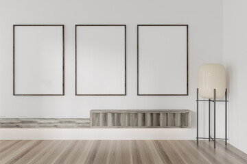 Bright gallery room interior with three empty white posters