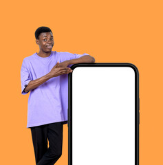 Poster - Black man hand point at phone, mockup display on orange background