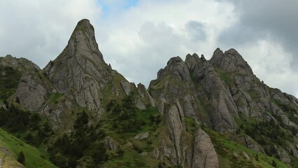 Wall Mural - Drone footage of a beautiful mountainous landscape with lush green nature and vegetation