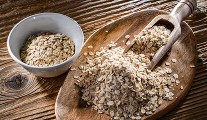 Wall Mural - Rolled oats on the wooden cutting board