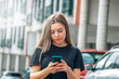 © tetxu - urban young girl using mobile phone in the street