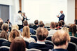 © kasto - I have a question. Group of business people sitting in conference hall. Businessman raising his arm. Conference and Presentation. Business and Entrepreneurship