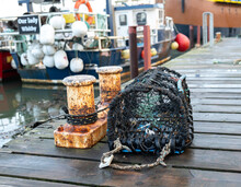Close And Selective Focus On A Crab Pot, Lobster Pot Or Fish Trap On The Side Of Whitby Docks At Dusk