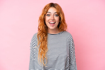 Wall Mural - young caucasian woman isolated on pink background with surprise facial expression