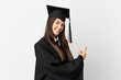 © luismolinero - Teenager Brazilian university graduate over isolated white background pointing back