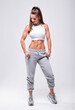 © andy_gin - Young white fitness woman wearing sportswear standing over white wall background. Fitness concept