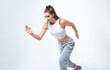 © andy_gin - Sports woman runner on a white background. Photo of an attractive woman in fashionable sportswear. Dynamic movement. Side view. Sports and healthy lifestyle