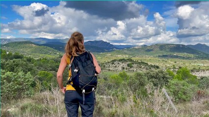 Wall Mural - Traveler woman admiring panoramic view ( Cévennes, Occitanie, France)