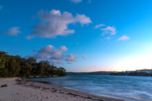 Blue Hour Photo Of Beach And Bay With Clouds In A Blue Sky