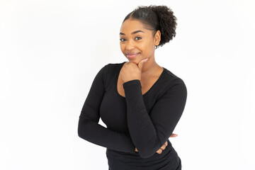 Wall Mural - Portrait of happy young woman looking at camera and smiling. African American lady wearing black longsleeve posing against white background. Female beauty concept