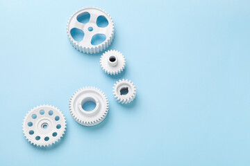 White gears wheels flat lay symbolizing idea, cooperation or teamwork, work and connection concept