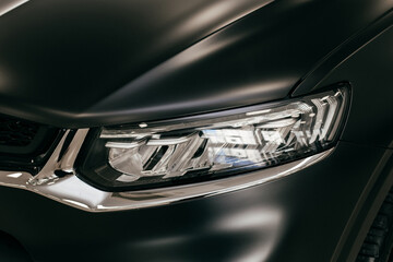 Wall Mural - Black car headlight close up, beautiful car design