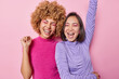 © wayhome.studio  - Happy overjoyed women dance and have fun keep arms raised dressed in casual jumpers exclaim loudly apply vivid bright makeup foolish around isolated over pink background. People and fun concept
