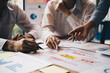 © PaeGAG - Close-up of businesspeople hands pointing a business plan sheet data,discussing, analyzing and brainstorming.