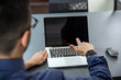 © VictorHugo - man showing a computer screen in front of him pointing finger