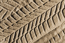 Sand Tyre Mark Background. Tire Track Shape. Trail Lines On Dry Brown Sand Pattern. Road Construction Site Backdrop. Heavy Machinery Imprint. Dried Mud Vehicle Wheel Shape.