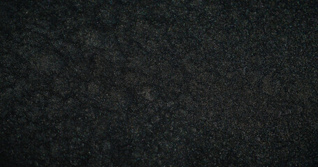 Grain texture abstract background. Blur dust. Uneven surface. Defocused black white glitter dark rough structure wallpaper with copy space.