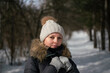 © Vectorina - Girl in winter clothes on the background of the forest in winter.